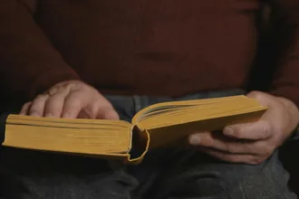 Hands holding an open book
